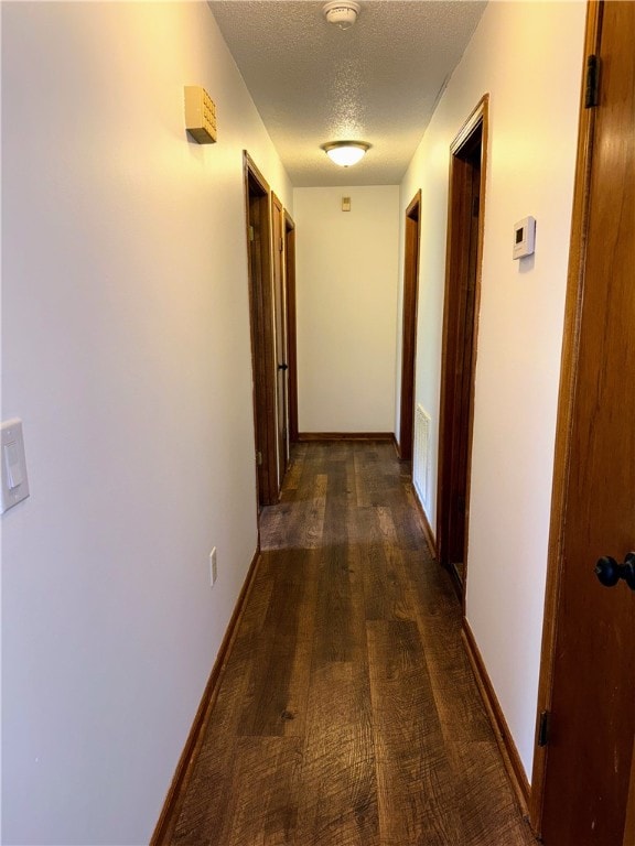 5265 Slater Rd, Anderson, SC 29621 - hall featuring a textured ceiling, dark wood finished floors, and baseboards