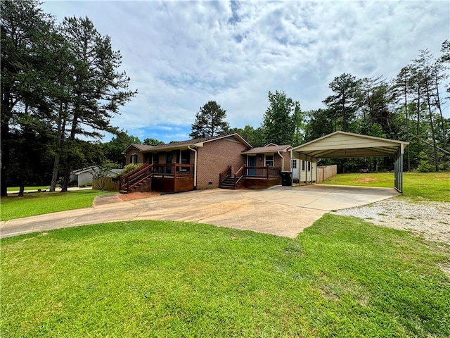 5265 Slater Rd, Anderson, SC 29621 - view of front of home featuring driveway, a detached carport, brick siding, and a front lawn