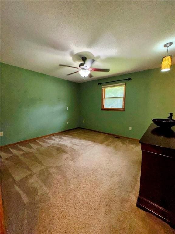 5265 Slater Rd, Anderson, SC 29621 - empty room featuring a sink, a ceiling fan, carpet floors, and a textured ceiling
