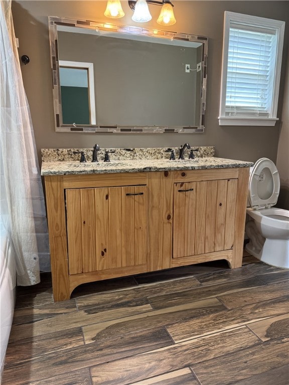 5265 Slater Rd, Anderson, SC 29621 - full bathroom featuring double vanity, toilet, and wood finished floors