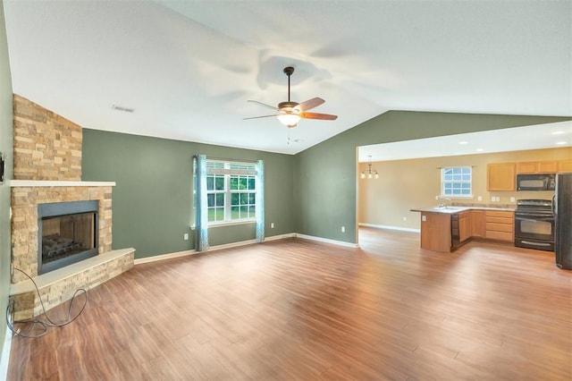 123 Stevens Ct, Williamston, SC 29697 - unfurnished living room featuring vaulted ceiling, ceiling fan, light wood-style flooring, a fireplace, and baseboards