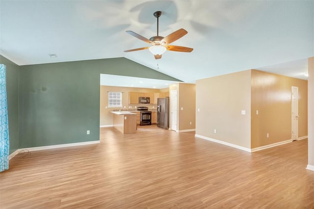 123 Stevens Ct, Williamston, SC 29697 - unfurnished living room featuring a ceiling fan, lofted ceiling, baseboards, and light wood finished floors