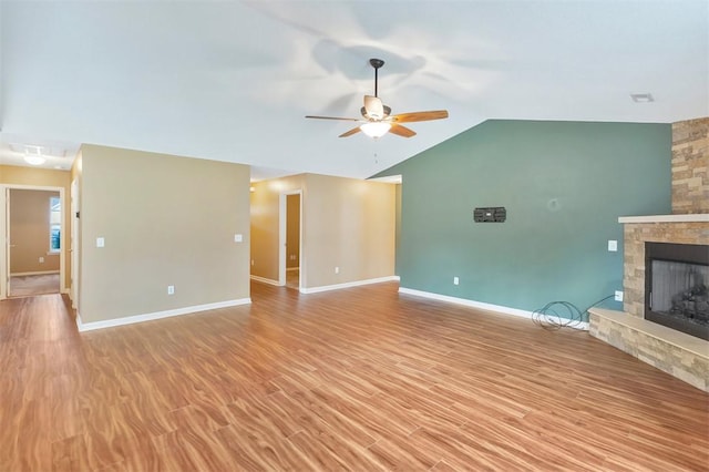 123 Stevens Ct, Williamston, SC 29697 - unfurnished living room featuring ceiling fan, a fireplace, vaulted ceiling, baseboards, and light wood-type flooring