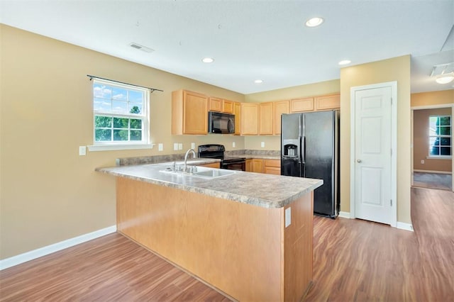 123 Stevens Ct, Williamston, SC 29697 - kitchen featuring black appliances, light brown cabinetry, a sink, a peninsula, and baseboards