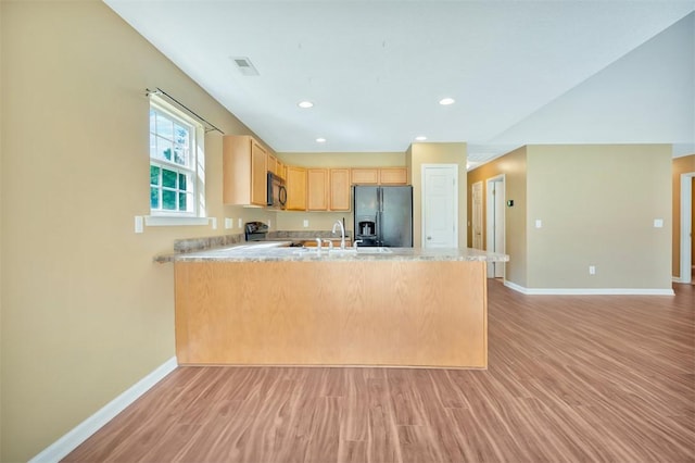 123 Stevens Ct, Williamston, SC 29697 - kitchen with black fridge with ice dispenser, a peninsula, baseboards, light wood finished floors, and recessed lighting