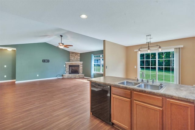 123 Stevens Ct, Williamston, SC 29697 - kitchen featuring black dishwasher, a sink, a fireplace, ceiling fan, and wood finished floors
