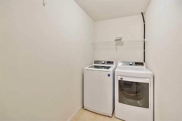 123 Stevens Ct, Williamston, SC 29697 - laundry room featuring washing machine and clothes dryer, light tile patterned flooring, and baseboards