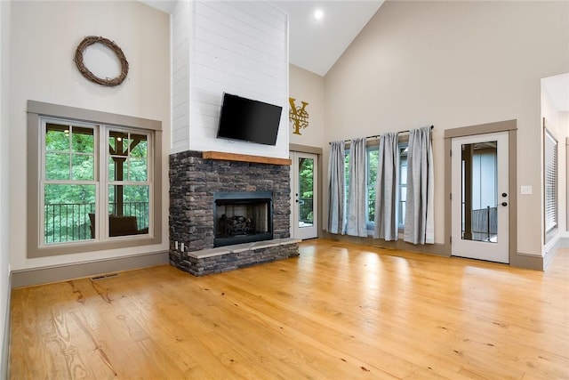 1104 Little River View Dr, Seneca, SC 29672 - unfurnished living room with high vaulted ceiling, a fireplace, and wood finished floors