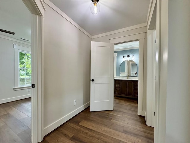 800 Holiday Dam Rd, Honea Path, SC 29654 - corridor with baseboards, dark wood-type flooring, a sink, and crown molding