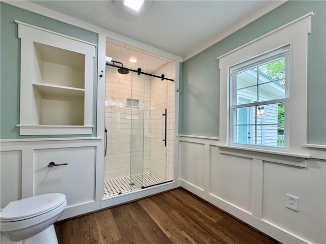 800 Holiday Dam Rd, Honea Path, SC 29654 - full bathroom with a shower stall, toilet, wainscoting, a decorative wall, and wood finished floors