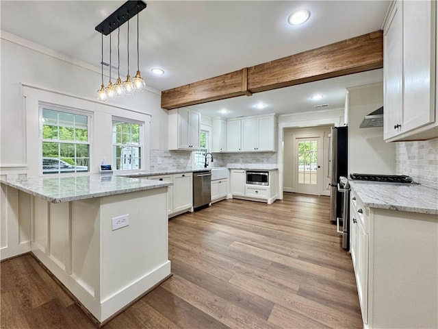 800 Holiday Dam Rd, Honea Path, SC 29654 - kitchen featuring stainless steel appliances, light wood-style flooring, wall chimney exhaust hood, backsplash, and white cabinets