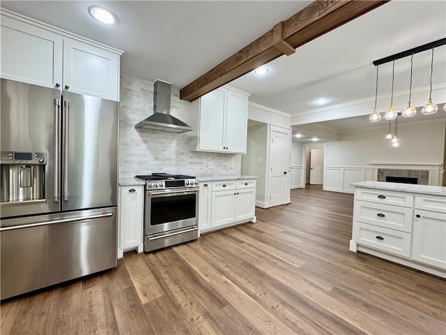800 Holiday Dam Rd, Honea Path, SC 29654 - kitchen with stainless steel appliances, wall chimney exhaust hood, light countertops, backsplash, and light wood-style floors