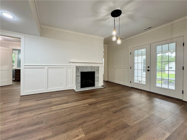 800 Holiday Dam Rd, Honea Path, SC 29654 - unfurnished living room with a decorative wall, crown molding, french doors, a fireplace with flush hearth, and wood finished floors