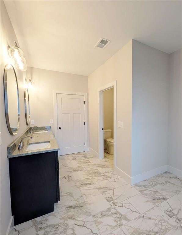 40 Pine Garden Way Dr, Salem, SC 29676 - bathroom with marble look tiles, double vanity, toilet, and baseboards