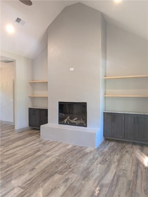 40 Pine Garden Way Dr, Salem, SC 29676 - unfurnished living room featuring lofted ceiling, a glass covered fireplace, and wood finished floors