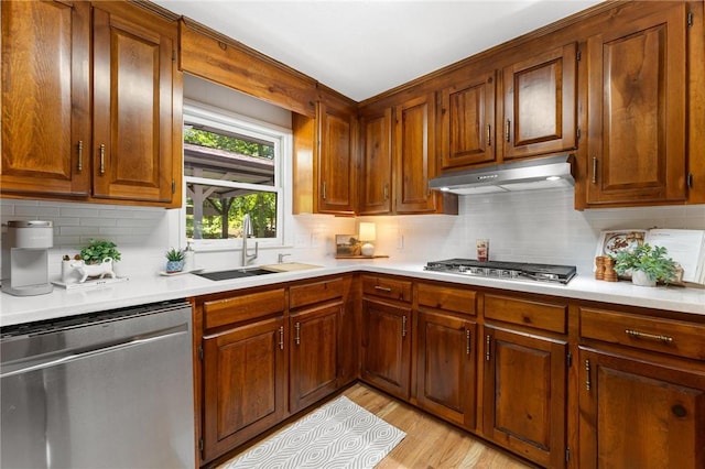 131 Shoreside Dr, Martin, GA 30557 - kitchen with stainless steel appliances, a sink, under cabinet range hood, light countertops, and decorative backsplash
