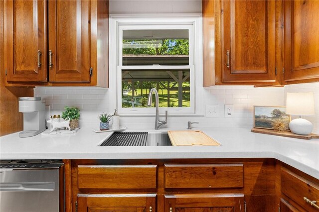 131 Shoreside Dr, Martin, GA 30557 - kitchen with a sink, light countertops, tasteful backsplash, brown cabinets, and stainless steel dishwasher