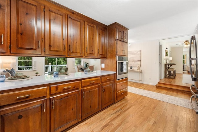 131 Shoreside Dr, Martin, GA 30557 - kitchen with stainless steel oven, light wood-style floors, and healthy amount of natural light