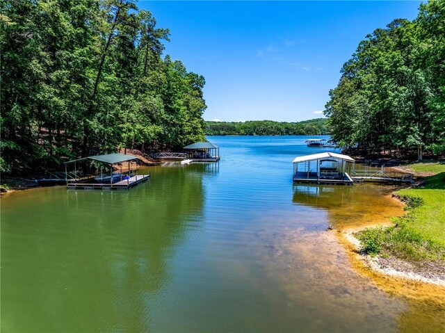 131 Shoreside Dr, Martin, GA 30557 - water view featuring a floating dock, boat lift, and a heavily wooded area
