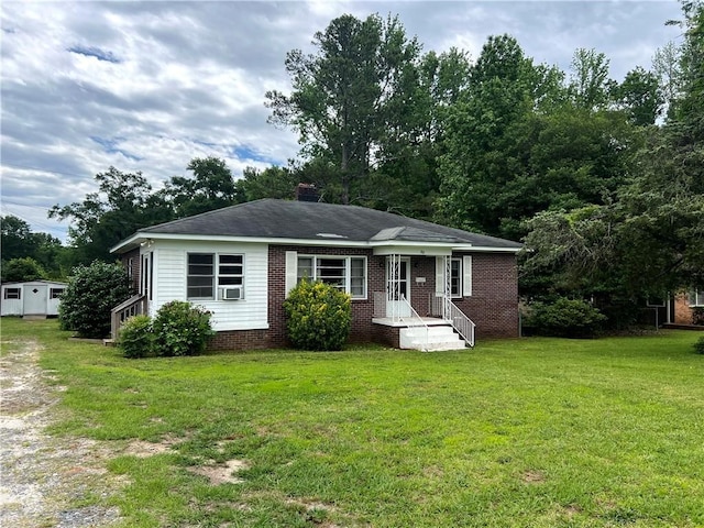 701 W Greer St, Honea Path, SC 29654 - view of front of house featuring a front yard, brick siding, and cooling unit