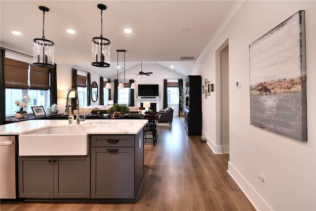 317 Encampment Blvd, Simpsonville, SC 29681 - kitchen with a sink, gray cabinetry, open floor plan, dishwasher, and vaulted ceiling