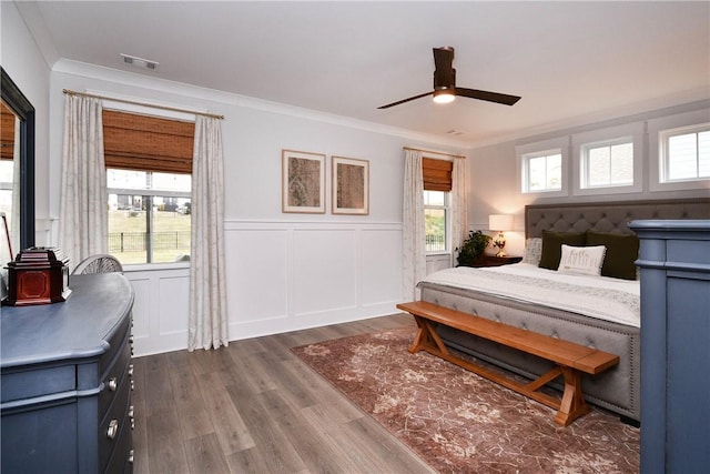 317 Encampment Blvd, Simpsonville, SC 29681 - bedroom featuring ornamental molding, dark wood-style floors, a wainscoted wall, a decorative wall, and ceiling fan