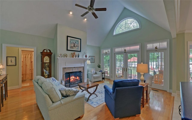138 Grandview Ct, Hartwell, GA 30643 - living room with a tile fireplace, a ceiling fan, light wood finished floors, high vaulted ceiling, and baseboards