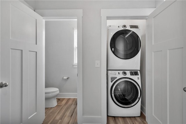 222 Grange Vally Ln, Central, SC 29630 - laundry area featuring stacked washer and clothes dryer, wood finished floors, and baseboards