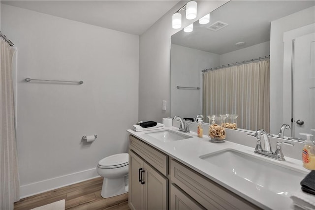 222 Grange Vally Ln, Central, SC 29630 - bathroom with wood finished floors, double vanity, toilet, baseboards, and a shower with curtain