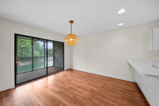 704 Loran Pointe Cir, Seneca, SC 29672 - unfurnished dining area with light wood-style flooring, baseboards, and recessed lighting