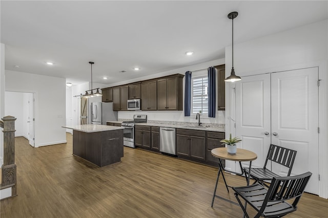 3401 Old Buncombe Rd, Greenville, SC 29617 - kitchen featuring stainless steel appliances, dark brown cabinets, a sink, a kitchen island, and dark wood-style flooring