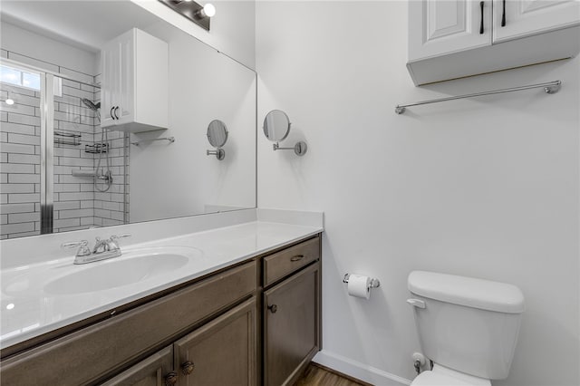 3401 Old Buncombe Rd, Greenville, SC 29617 - bathroom with toilet, vanity, a tile shower, baseboards, and wood finished floors