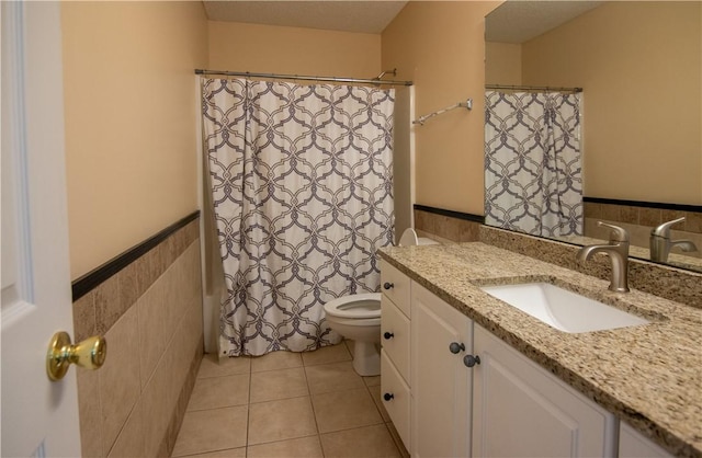 124 Grand Oak Cir, Pendleton, SC 29670 - full bath with vanity, toilet, wainscoting, tile patterned floors, and tile walls