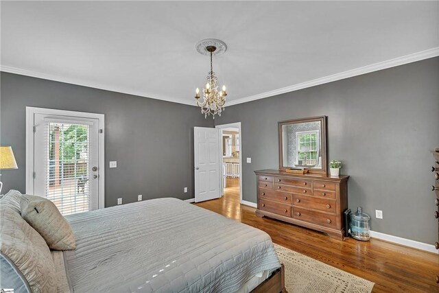 120 Red Maple Cir, Easley, SC 29642 - bedroom featuring a chandelier, access to outside, crown molding, baseboards, and wood finished floors