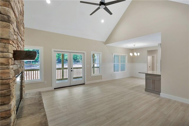 32 Pine Garden Way Dr, Salem, SC 29676 - unfurnished living room featuring a chandelier, ceiling fan, wainscoting, high vaulted ceiling, and light wood-style floors