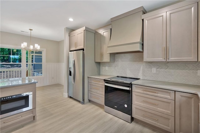 32 Pine Garden Way Dr, Salem, SC 29676 - kitchen with stainless steel appliances, premium range hood, light wood finished floors, wainscoting, and a chandelier