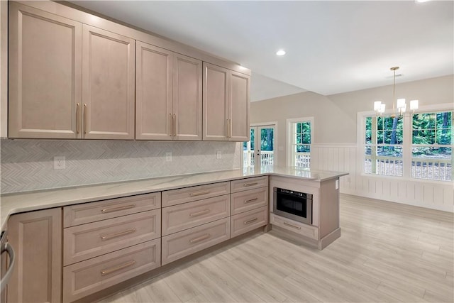 32 Pine Garden Way Dr, Salem, SC 29676 - kitchen with oven, a peninsula, a chandelier, a wainscoted wall, and light wood-style flooring