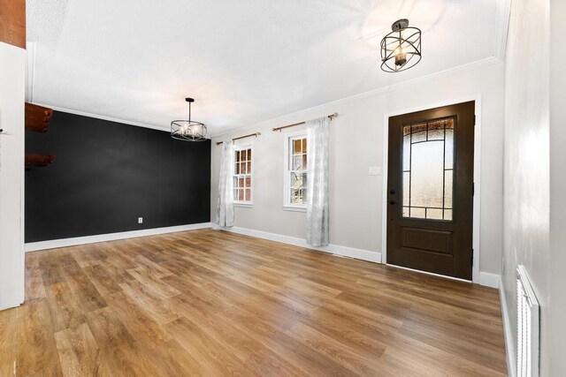 113 Woodhurst Dr, Hartwell, GA 30643 - entrance foyer featuring a chandelier, ornamental molding, light wood-type flooring, and baseboards