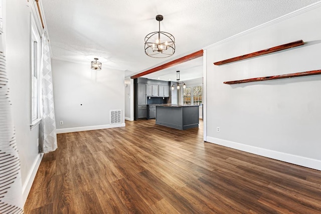 113 Woodhurst Dr, Hartwell, GA 30643 - unfurnished living room featuring a chandelier, dark wood-type flooring, baseboards, a textured ceiling, and crown molding