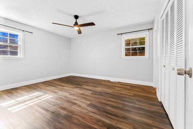 113 Woodhurst Dr, Hartwell, GA 30643 - unfurnished bedroom featuring dark wood-style floors, baseboards, a closet, and a ceiling fan