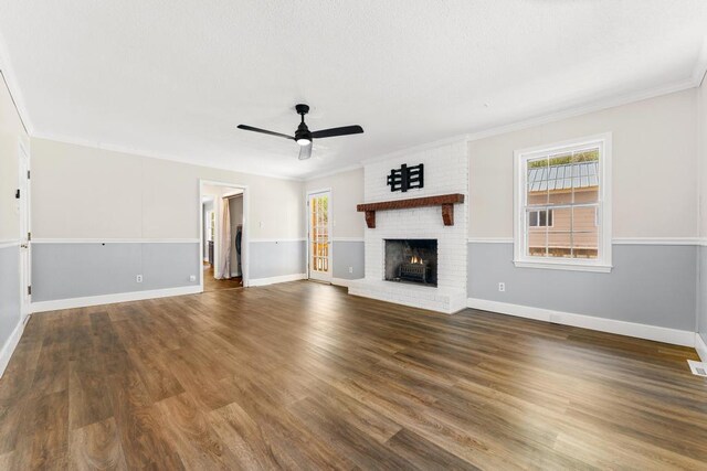 113 Woodhurst Dr, Hartwell, GA 30643 - unfurnished living room with ceiling fan, ornamental molding, a brick fireplace, baseboards, and wood finished floors