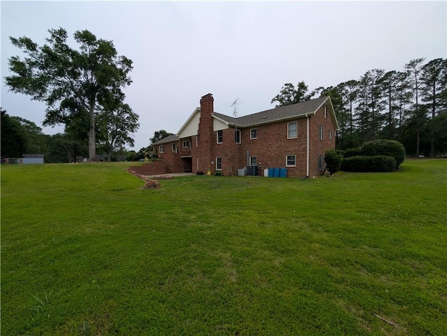 106 Emma Dr, Honea Path, SC 29654 - rear view of property featuring a chimney, brick siding, a lawn, and cooling unit