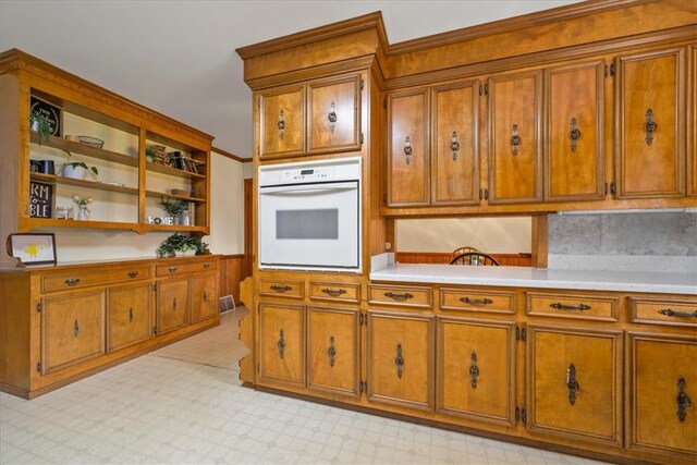 106 Emma Dr, Honea Path, SC 29654 - kitchen featuring oven, brown cabinets, open shelves, light countertops, and backsplash