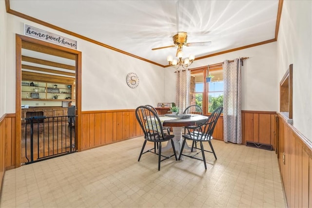 106 Emma Dr, Honea Path, SC 29654 - dining room featuring a wainscoted wall, crown molding, wooden walls, and ceiling fan