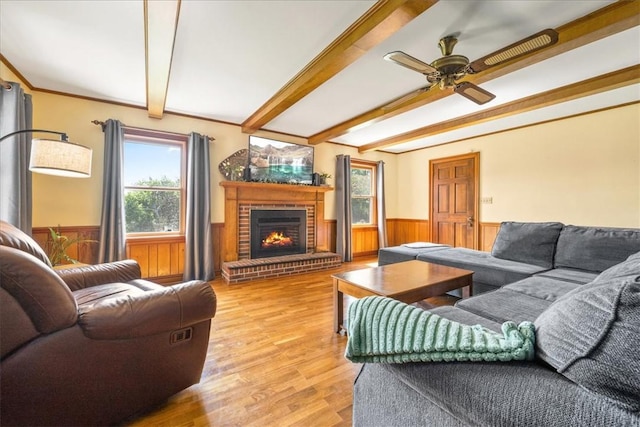 106 Emma Dr, Honea Path, SC 29654 - living area featuring wainscoting, beam ceiling, wooden walls, a brick fireplace, and ceiling fan