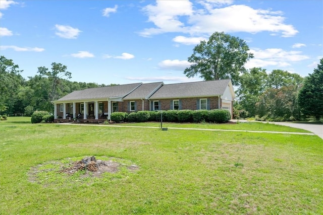 106 Emma Dr, Honea Path, SC 29654 - ranch-style house featuring a front lawn, an attached garage, a fire pit, and brick siding