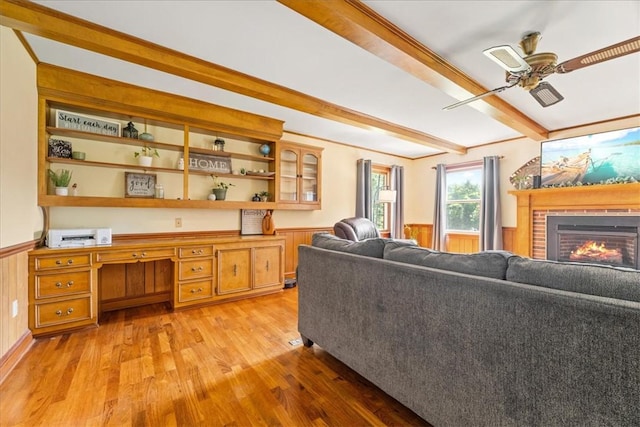 106 Emma Dr, Honea Path, SC 29654 - living room with a ceiling fan, beam ceiling, a wainscoted wall, light wood finished floors, and a fireplace