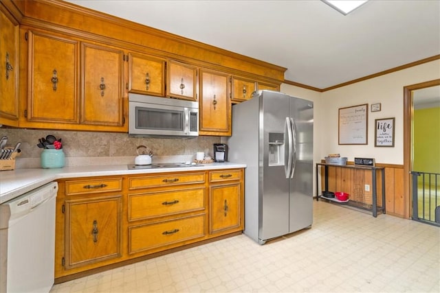 106 Emma Dr, Honea Path, SC 29654 - kitchen featuring appliances with stainless steel finishes, brown cabinetry, light countertops, light floors, and crown molding