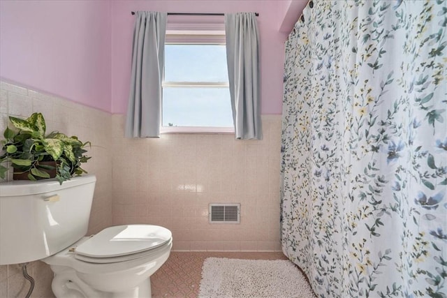 106 Emma Dr, Honea Path, SC 29654 - full bathroom featuring tile walls, tile patterned floors, a shower with curtain, and a wainscoted wall