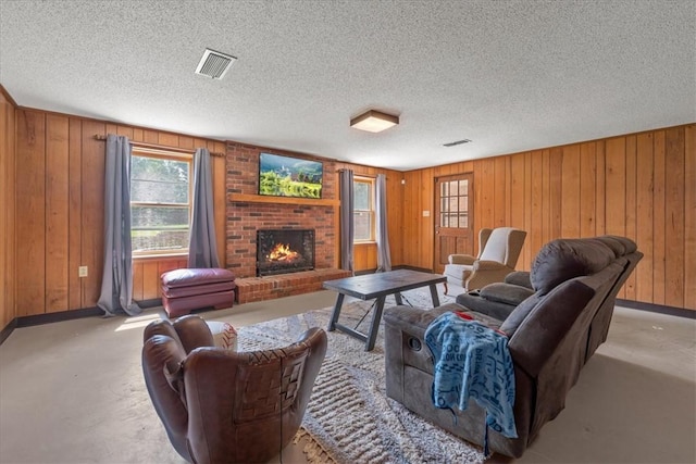 106 Emma Dr, Honea Path, SC 29654 - living area with wooden walls, a brick fireplace, finished concrete floors, and a textured ceiling